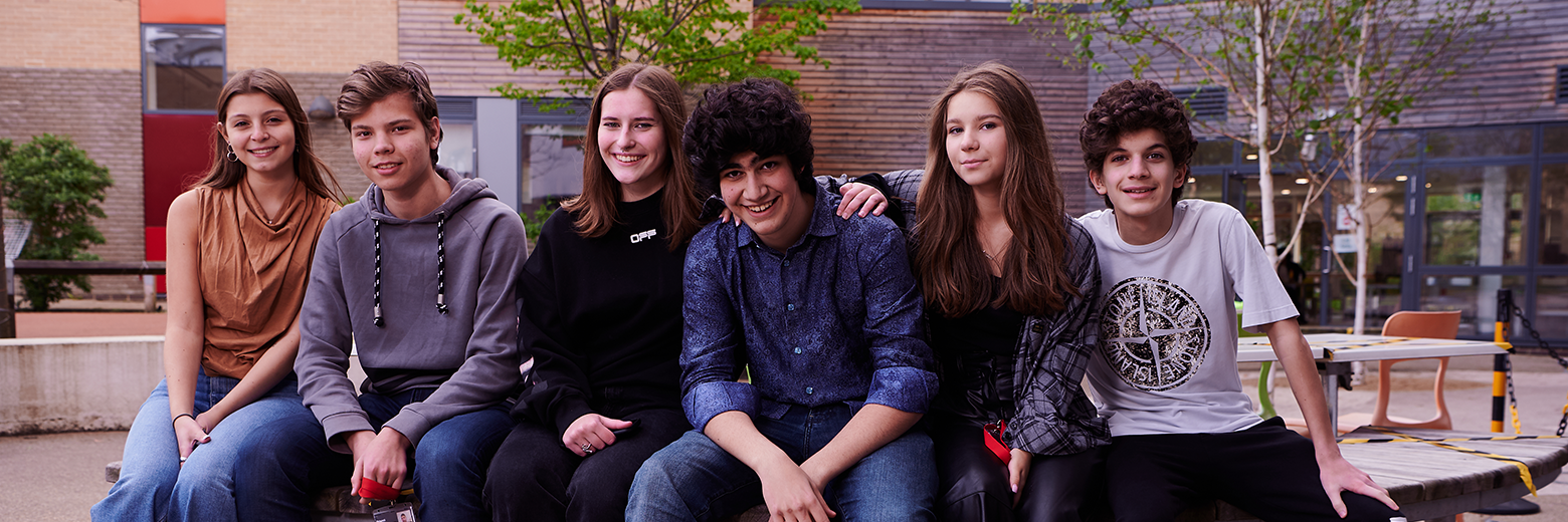 Group Of Students Relaxing In Abbey College Cambridge Courtyard
