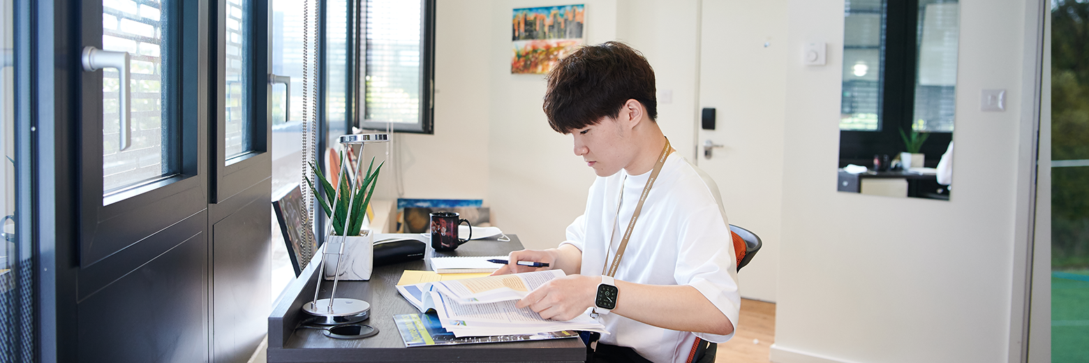 Student Working In His Bedroom At DLD College London