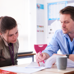 Student and teacher working together in business foundation class