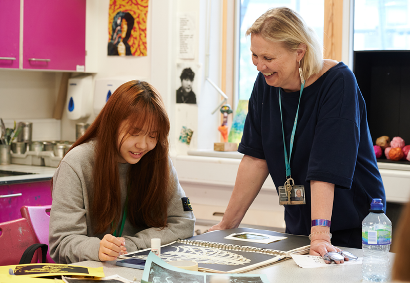 Student and teacher working in Art class