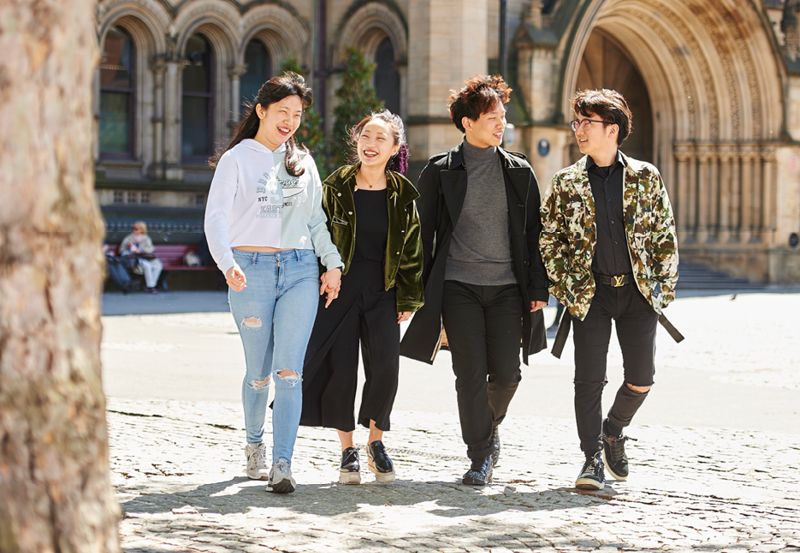 Students Walking Outside School Buildings In Manchester, UK