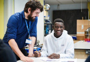 Teacher And Male Student In Science Class At Abbey College Manchester