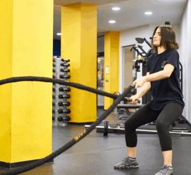 Female Stuent Excercising In The Gym At DLD College London