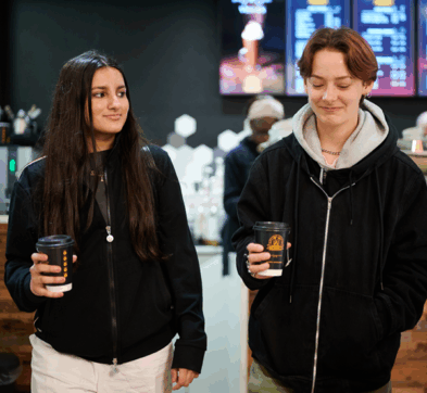 Female Students Getting A Coffee In Manchester City Centre
