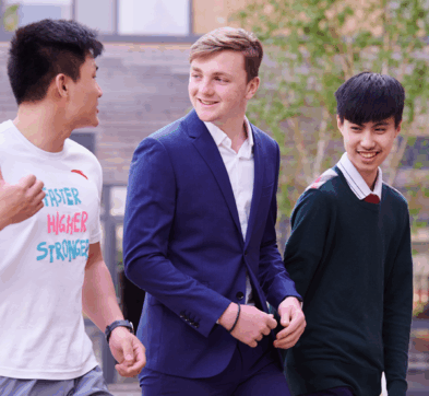 Male Students Walking In The Abbey College Cambrdieg Courtyard