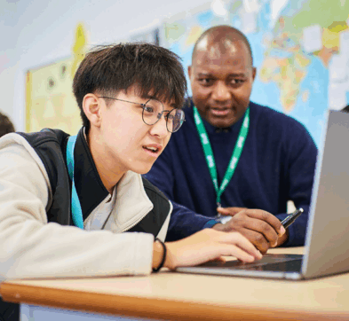 Student And Teacher In Business Class At Abbey College Cambridge