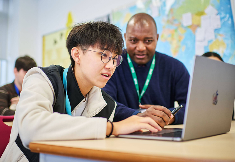 Student And Teacher In Business Class At Abbey College Cambridge