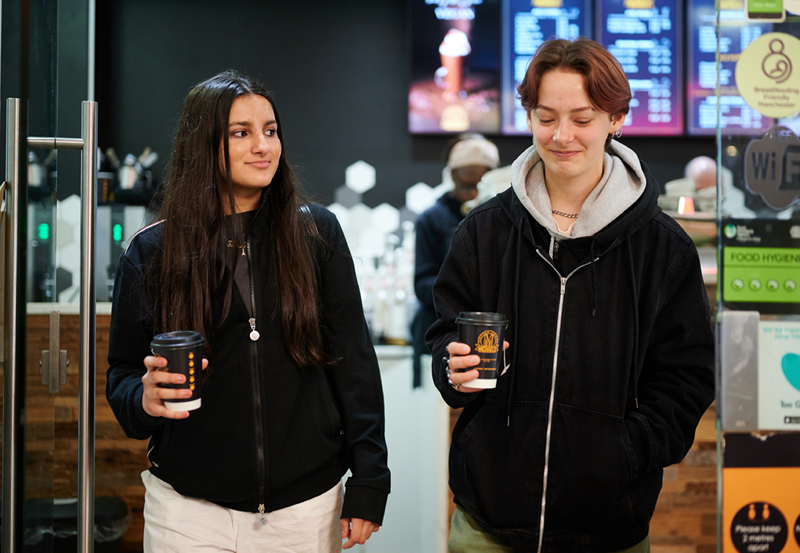 Female Students Getting A Coffee In Manchester City Centre
