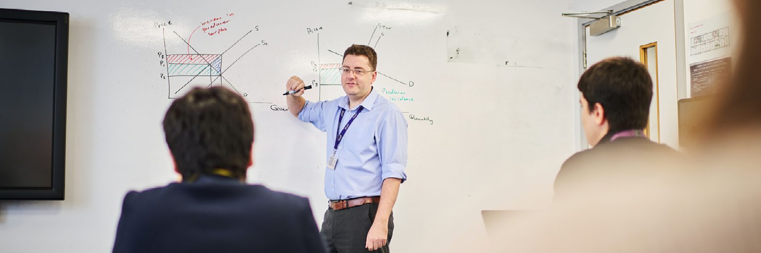 Teacher And Students In Economics Class