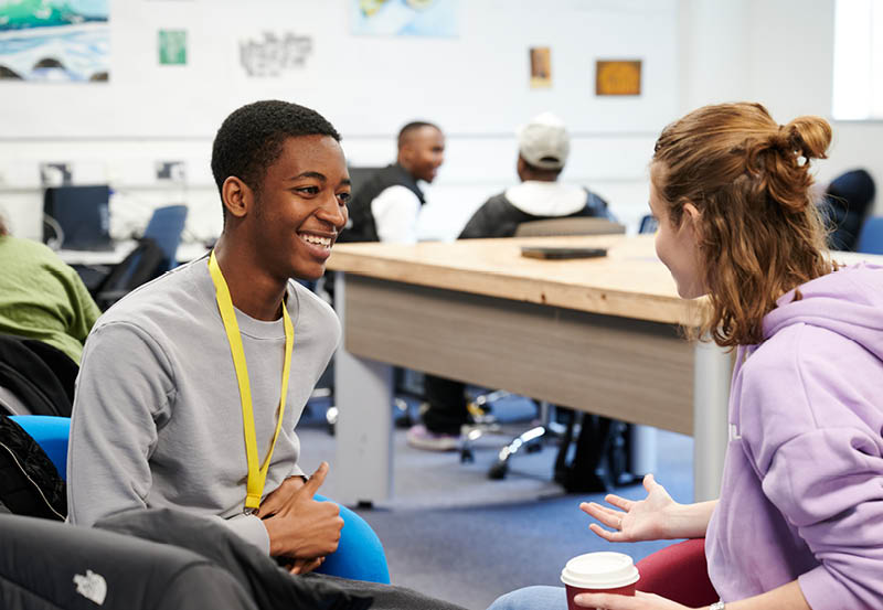 Students Relaxing In Common Room At Abbey College Cambridge